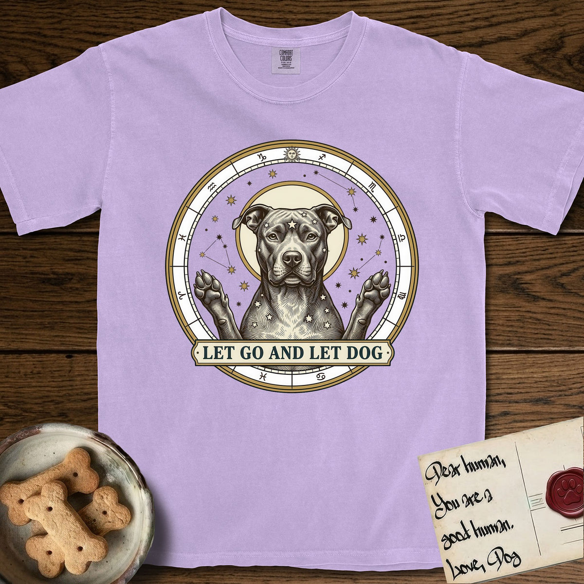 Let Go and Let Dog Pitbull T-Shirt flat lay in Orchid, featuring an antique engraved celestial star chart with a haloed Pitbull at the center, natural folded ears and paws raised, stars carved across his coat.