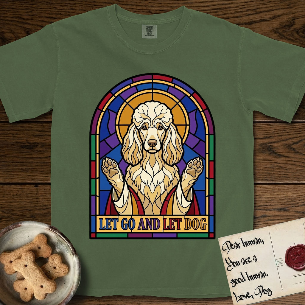 Let Go and Let Dog Poodle T-Shirt flat lay in Moss, featuring a stained-glass illustration of a haloed Poodle with paws raised.