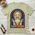 Let Go and Let Dog Poodle T-Shirt flat lay in Pistachio, featuring a stained-glass illustration of a haloed Poodle with paws raised.