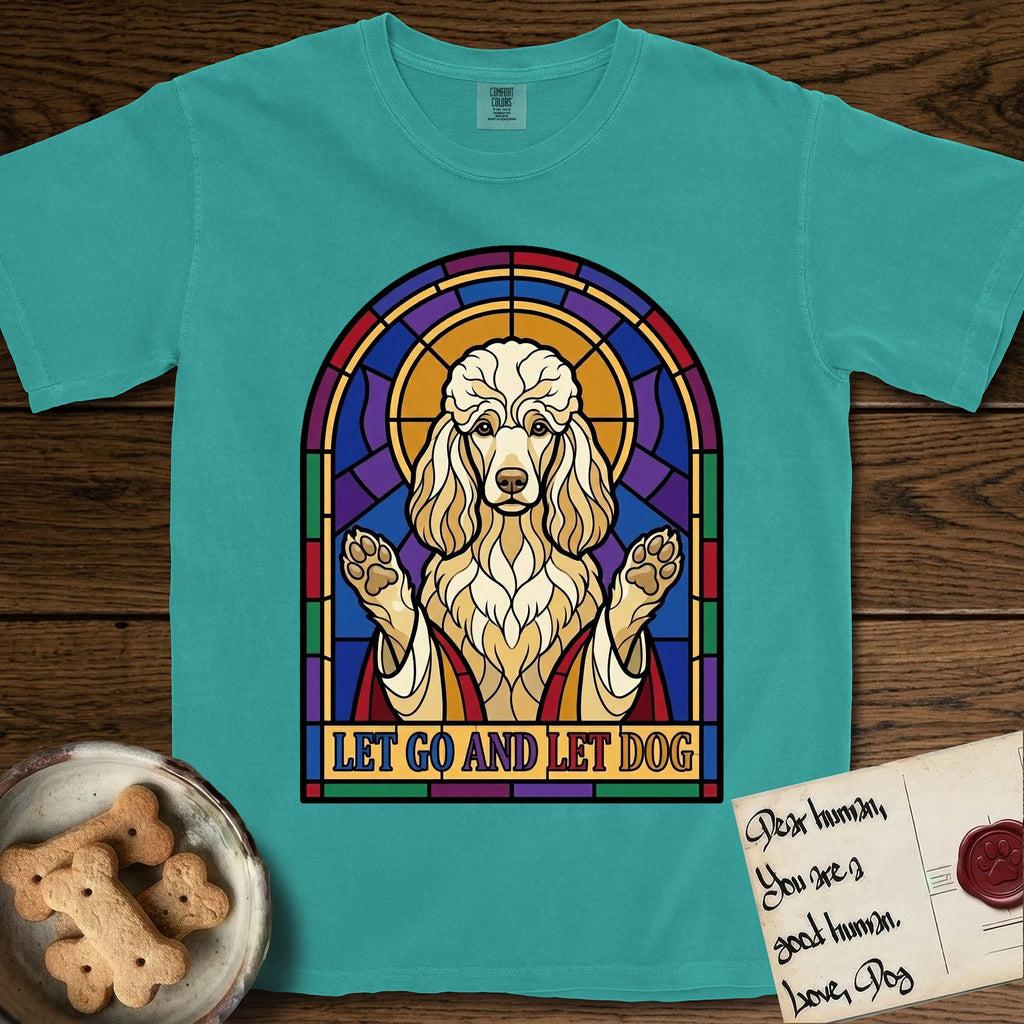 Let Go and Let Dog Poodle T-Shirt flat lay in Seafoam, featuring a stained-glass illustration of a haloed Poodle with paws raised.