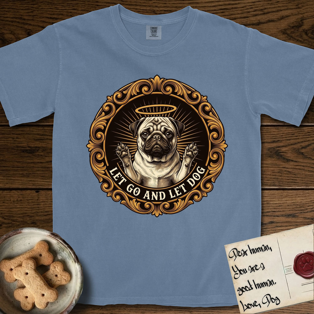 Let Go and Let Dog Pug T-Shirt flat lay in Blue Jean, featuring a baroque medallion engraving of a haloed Pug with paws raised, framed in gold scrollwork.