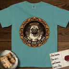 Let Go and Let Dog Pug T-Shirt flat lay in Blue Spruce, featuring a baroque medallion engraving of a haloed Pug with paws raised, framed in gold scrollwork.