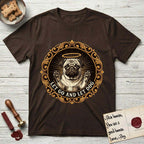 Let Go and Let Dog Pug T-Shirt flat lay in Dark Chocolate, featuring a baroque medallion engraving of a haloed Pug with paws raised, framed in gold scrollwork.
