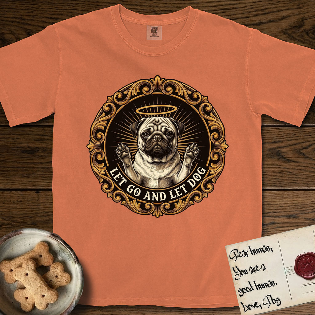 Let Go and Let Dog Pug T-Shirt flat lay in Melon, featuring a baroque medallion engraving of a haloed Pug with paws raised, framed in gold scrollwork.