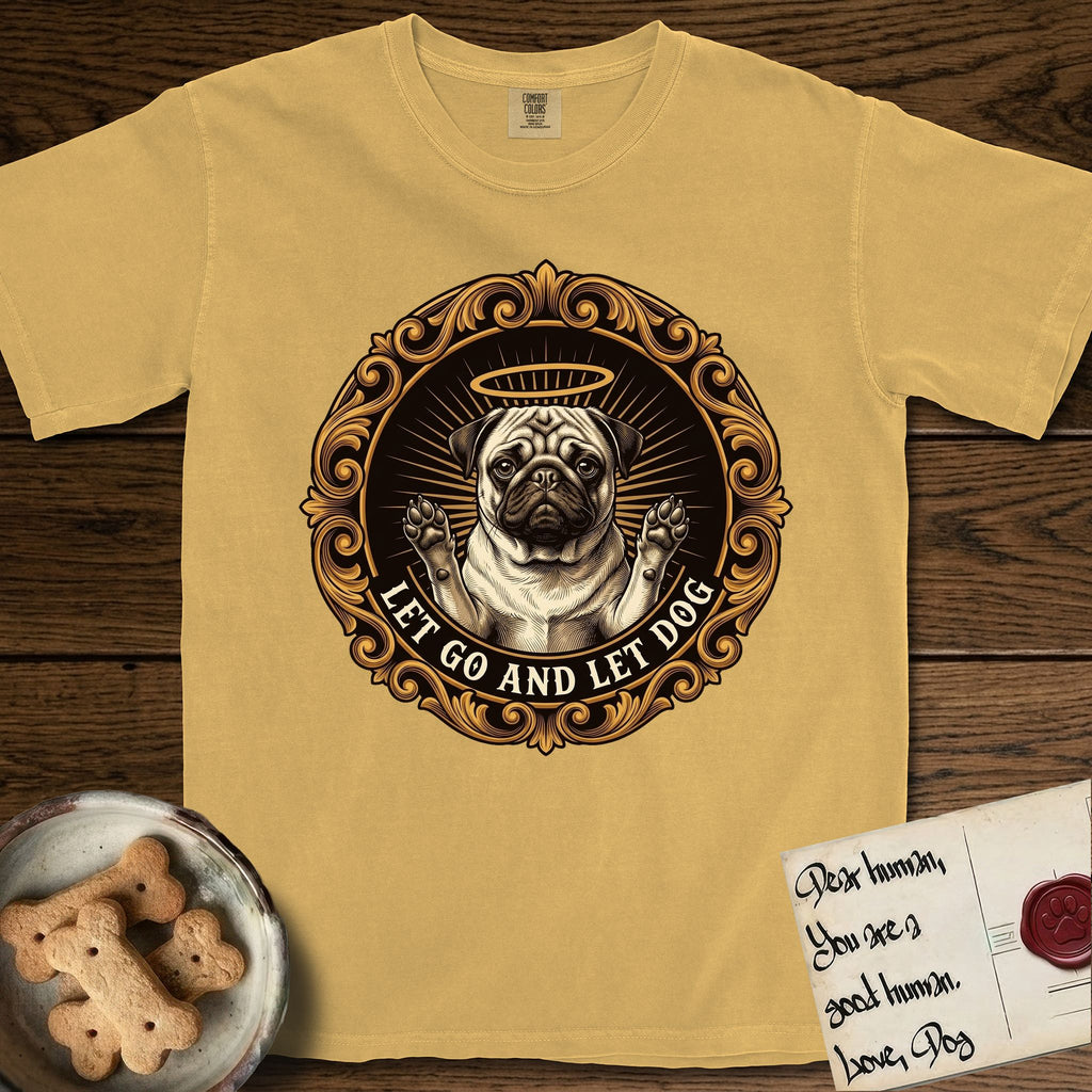 Let Go and Let Dog Pug T-Shirt flat lay in Mustard, featuring a baroque medallion engraving of a haloed Pug with paws raised, framed in gold scrollwork.