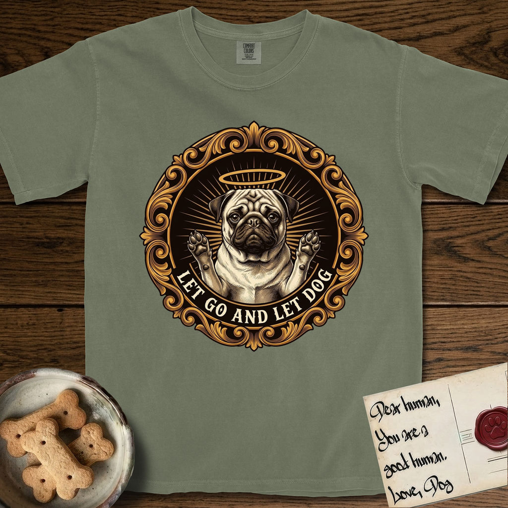 Let Go and Let Dog Pug T-Shirt flat lay in Sage, featuring a baroque medallion engraving of a haloed Pug with paws raised, framed in gold scrollwork.