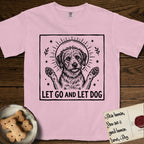 Let Go and Let Dog Rescue Mutt T-Shirt flat lay in Blossom, featuring a bold black-and-white woodcut of a haloed scruffy rescue mutt with both front paws raised.