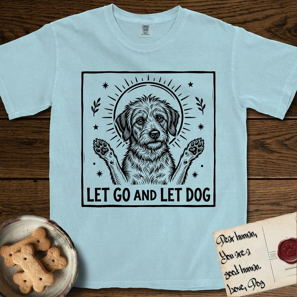 Let Go and Let Dog Rescue Mutt T-Shirt flat lay in Chambray, featuring a bold black-and-white woodcut of a haloed scruffy rescue mutt with both front paws raised.