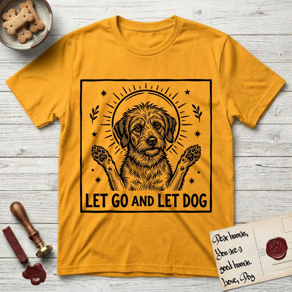 Let Go and Let Dog Rescue Mutt T-Shirt flat lay in Gold, featuring a bold black-and-white woodcut of a haloed scruffy rescue mutt with both front paws raised.