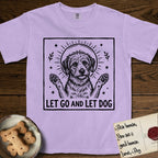 Let Go and Let Dog Rescue Mutt T-Shirt flat lay in Orchid, featuring a bold black-and-white woodcut of a haloed scruffy rescue mutt with both front paws raised.