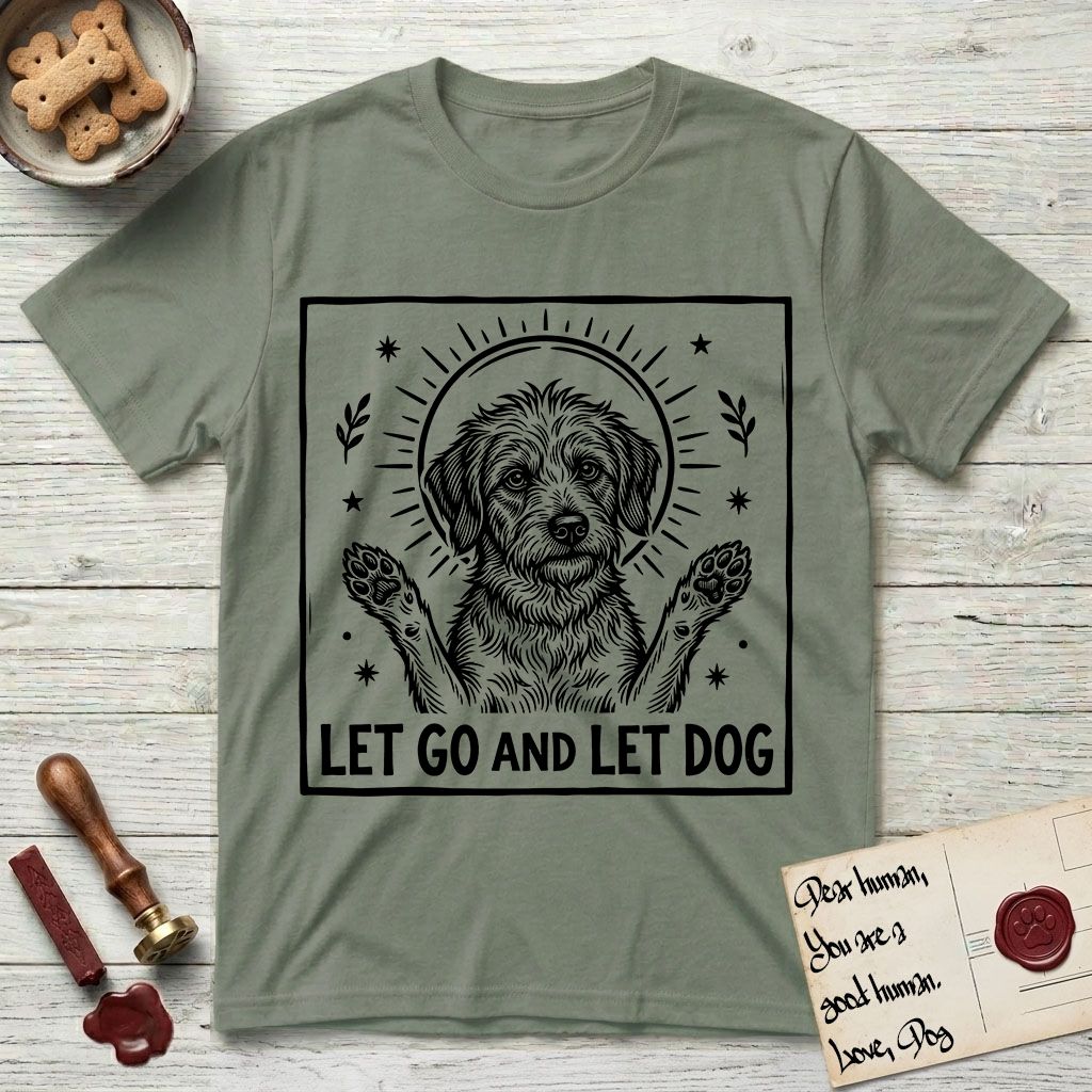 Let Go and Let Dog Rescue Mutt T-Shirt flat lay in Sage, featuring a bold black-and-white woodcut of a haloed scruffy rescue mutt with both front paws raised.