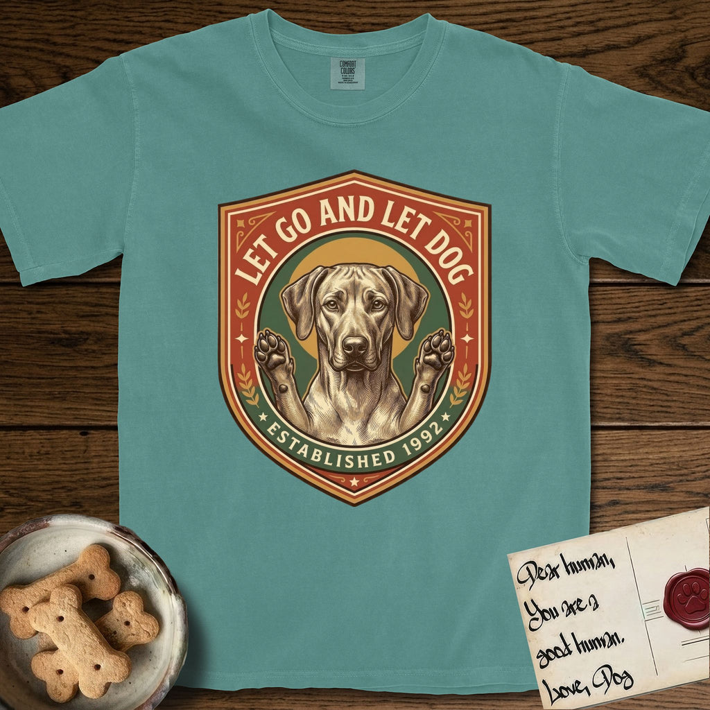 Let Go and Let Dog Rhodesian Ridgeback T-Shirt flat lay in Blue Spruce, featuring a vintage engraved crest of a haloed Rhodesian Ridgeback with front paws raised.