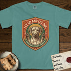 Let Go and Let Dog Rhodesian Ridgeback T-Shirt flat lay in Blue Spruce, featuring a vintage engraved crest of a haloed Rhodesian Ridgeback with front paws raised.