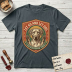 Let Go and Let Dog Rhodesian Ridgeback T-Shirt flat lay in Dark Heather Grey, featuring a vintage engraved crest of a haloed Rhodesian Ridgeback with front paws raised.