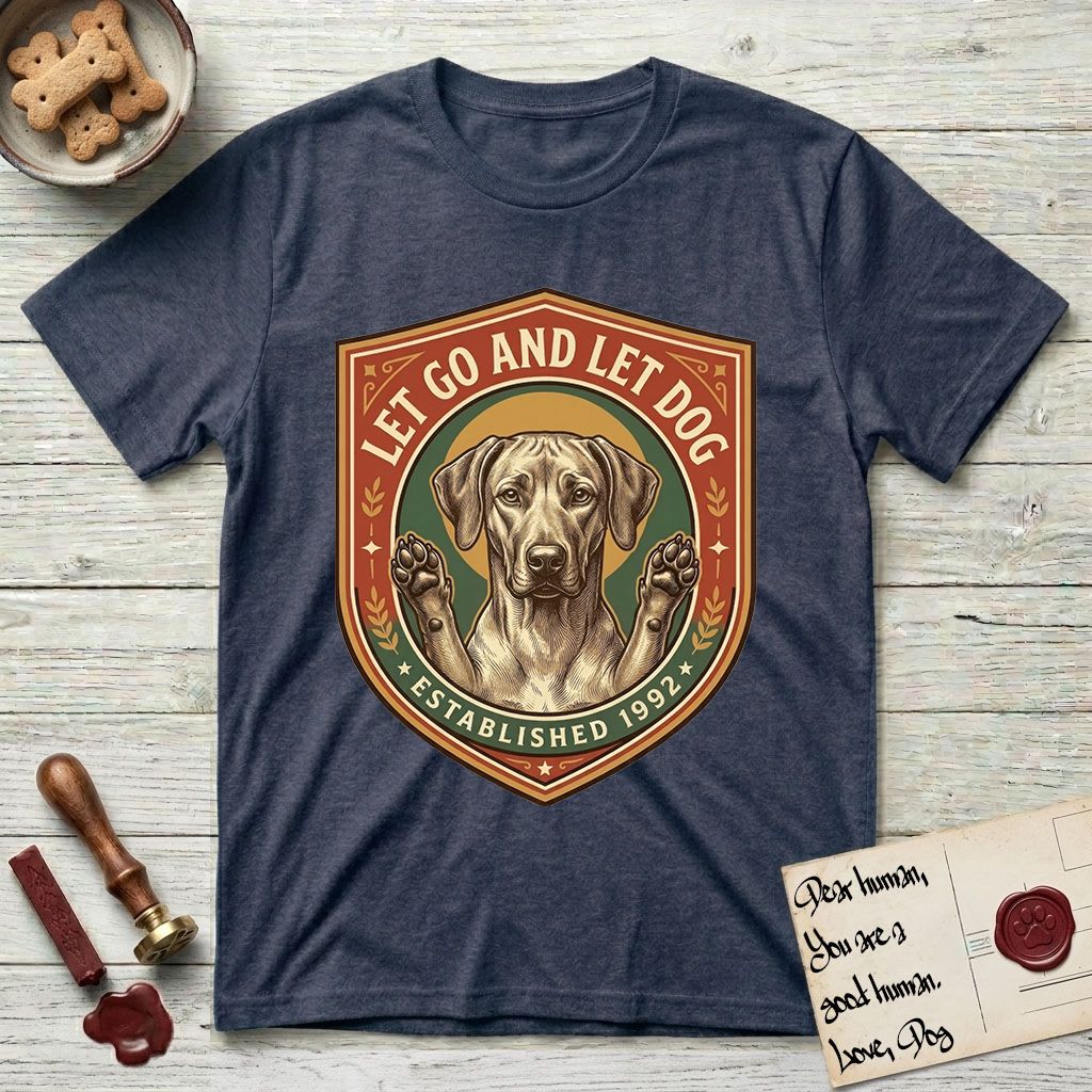 Let Go and Let Dog Rhodesian Ridgeback T-Shirt flat lay in Heather Navy, featuring a vintage engraved crest of a haloed Rhodesian Ridgeback with front paws raised.