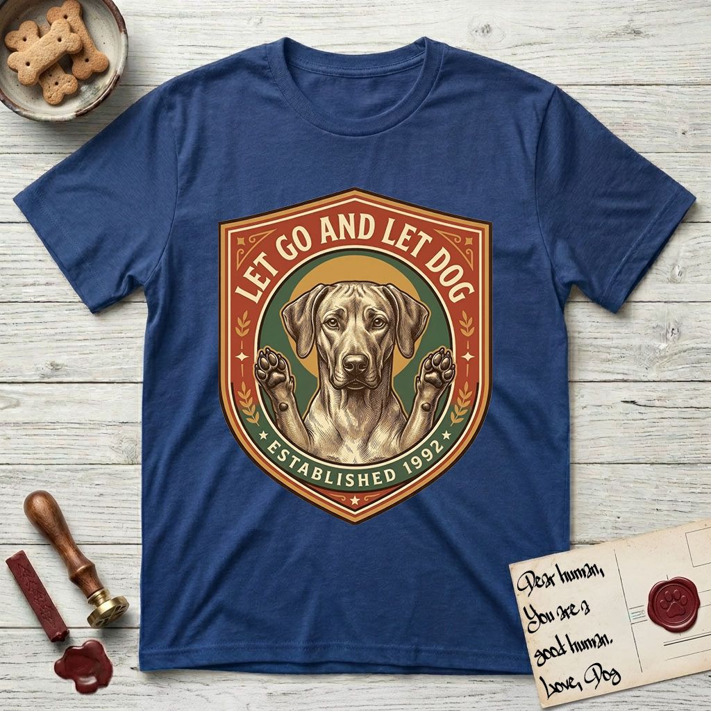 Let Go and Let Dog Rhodesian Ridgeback T-Shirt flat lay in Royal, featuring a vintage engraved crest of a haloed Rhodesian Ridgeback with front paws raised.