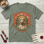 Let Go and Let Dog Rhodesian Ridgeback T-Shirt flat lay in Sage, featuring a vintage engraved crest of a haloed Rhodesian Ridgeback with front paws raised.