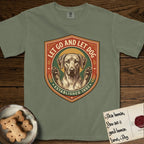 Let Go and Let Dog Rhodesian Ridgeback T-Shirt flat lay in Sage, featuring a vintage engraved crest of a haloed Rhodesian Ridgeback with front paws raised.
