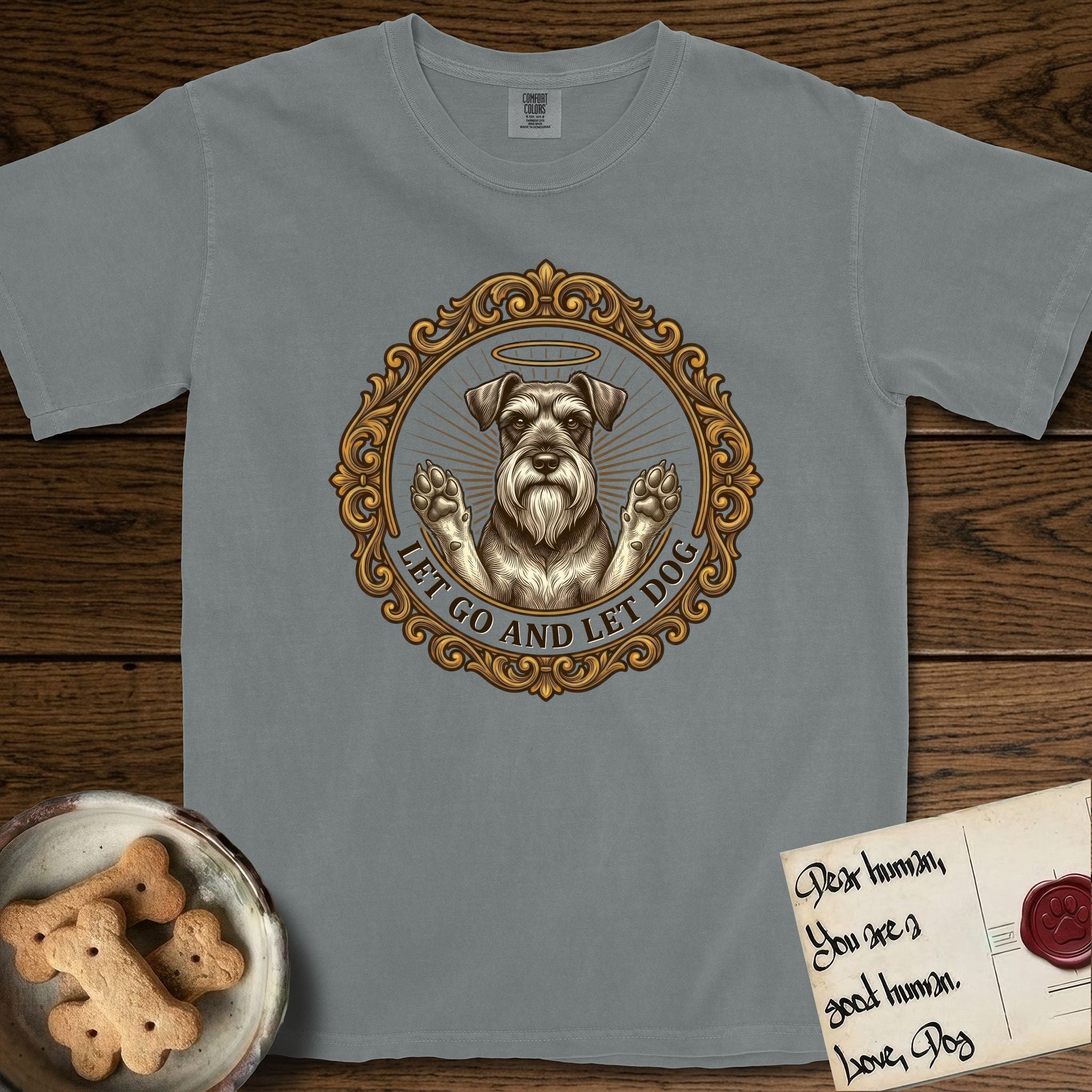 Let Go and Let Dog Schnauzer T-Shirt flat lay in Granite, featuring an ornate gilded medallion of a haloed Schnauzer with front paws raised.