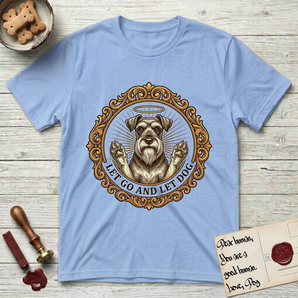Let Go and Let Dog Schnauzer T-Shirt flat lay in Light Blue, featuring an ornate gilded medallion of a haloed Schnauzer with front paws raised.