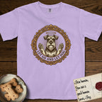 Let Go and Let Dog Schnauzer T-Shirt flat lay in Orchid, featuring an ornate gilded medallion of a haloed Schnauzer with front paws raised.