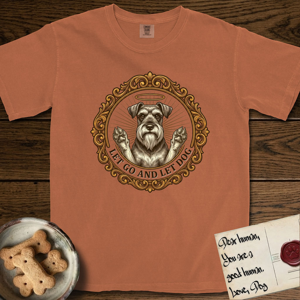Let Go and Let Dog Schnauzer T-Shirt flat lay in Yam, featuring an ornate gilded medallion of a haloed Schnauzer with front paws raised.
