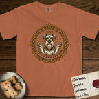 Let Go and Let Dog Schnauzer T-Shirt flat lay in Yam, featuring an ornate gilded medallion of a haloed Schnauzer with front paws raised.