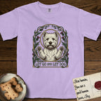 Let Go and Let Dog Westie T-Shirt flat lay in Orchid, featuring an Art Nouveau arch of thistles and curling vines around a haloed West Highland White Terrier, paws raised.