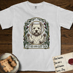 Let Go and Let Dog Westie T-Shirt flat lay in White, featuring an Art Nouveau arch of thistles and curling vines around a haloed West Highland White Terrier, paws raised.