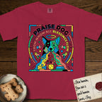 Praise Dog From Whom All Blessings Flow Australian Cattle Dog T-Shirt flat lay in Chili, featuring a neon pop-art illustration of an abstract Australian Cattle Dog with bold outlined "Praise Dog From Whom All Blessings Flow" lettering.