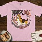 Praise Dog From Whom All Blessings Flow Basset Hound T-Shirt flat lay in Blossom, featuring an art nouveau hand-lettered design with a sad-eyed Basset Hound sitting beside a golden laurel sprig and the words Praise Dog From Whom All Blessings Flow.