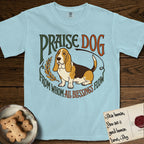 Praise Dog From Whom All Blessings Flow Basset Hound T-Shirt flat lay in Chambray, featuring an art nouveau hand-lettered design with a sad-eyed Basset Hound sitting beside a golden laurel sprig and the words Praise Dog From Whom All Blessings Flow.