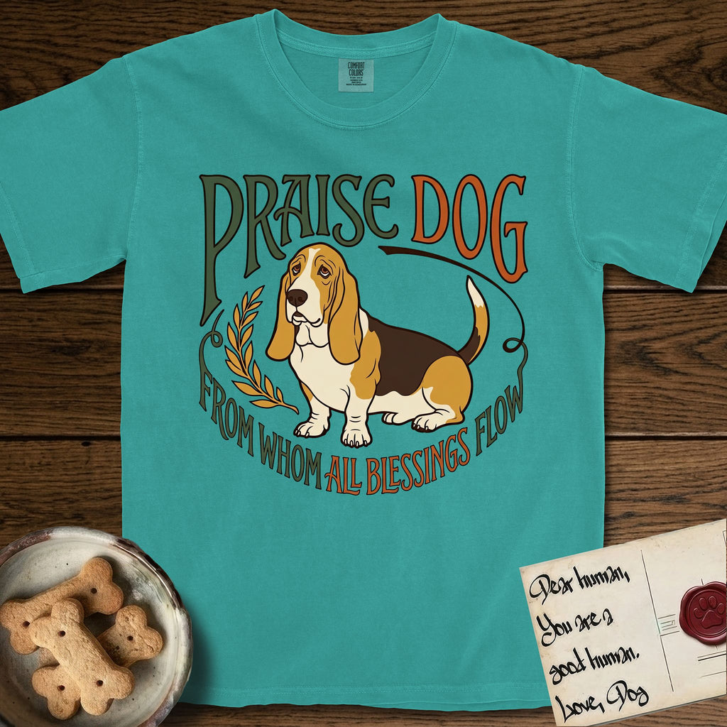 Praise Dog From Whom All Blessings Flow Basset Hound T-Shirt flat lay in Seafoam, featuring an art nouveau hand-lettered design with a sad-eyed Basset Hound sitting beside a golden laurel sprig and the words Praise Dog From Whom All Blessings Flow.