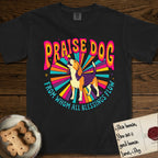 Praise Dog From Whom All Blessings Flow Beagle T-Shirt flat lay in Black, featuring a groovy psychedelic sunburst design with a Beagle howling skyward at the center and the words Praise Dog From Whom All Blessings Flow in rainbow bubble letters.