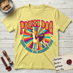 Praise Dog From Whom All Blessings Flow Beagle T-Shirt flat lay in Cornsilk, featuring a groovy psychedelic sunburst design with a Beagle howling skyward at the center and the words Praise Dog From Whom All Blessings Flow in rainbow bubble letters.