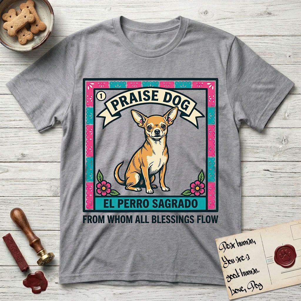 Praise Dog From Whom All Blessings Flow Chihuahua T-Shirt flat lay in Sport Grey, featuring a loteria-style folk art card with a Chihuahua seated inside a papel picado border, a banner reading El Perro Sagrado, and the words Praise Dog From Whom All Blessings Flow.