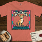 Praise Dog From Whom All Blessings Flow Chihuahua T-Shirt flat lay in Terracotta, featuring a loteria-style folk art card with a Chihuahua seated inside a papel picado border, a banner reading El Perro Sagrado, and the words Praise Dog From Whom All Blessings Flow.