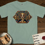 Praise Dog From Whom All Blessings Flow Corgi T-Shirt flat lay in Bay, featuring a jeweled baroque throne emblem with a Corgi at center, a golden gemstone frame, raised golden hands in blessing, and the words Praise Dog.