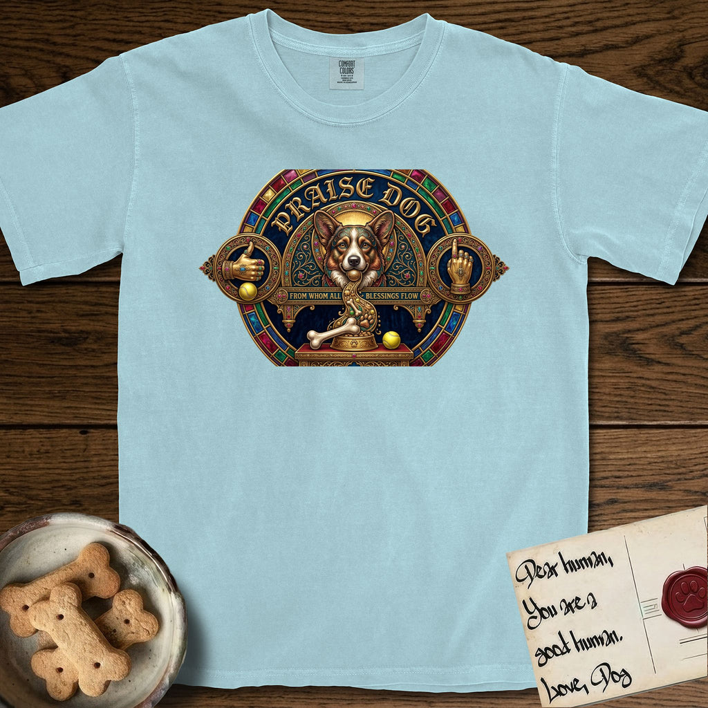 Praise Dog From Whom All Blessings Flow Corgi T-Shirt flat lay in Chambray, featuring a jeweled baroque throne emblem with a Corgi at center, a golden gemstone frame, raised golden hands in blessing, and the words Praise Dog.