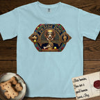 Praise Dog From Whom All Blessings Flow Corgi T-Shirt flat lay in Chambray, featuring a jeweled baroque throne emblem with a Corgi at center, a golden gemstone frame, raised golden hands in blessing, and the words Praise Dog.
