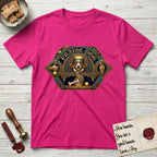 Praise Dog From Whom All Blessings Flow Corgi T-Shirt flat lay in Heliconia, featuring a jeweled baroque throne emblem with a Corgi at center, a golden gemstone frame, raised golden hands in blessing, and the words Praise Dog.