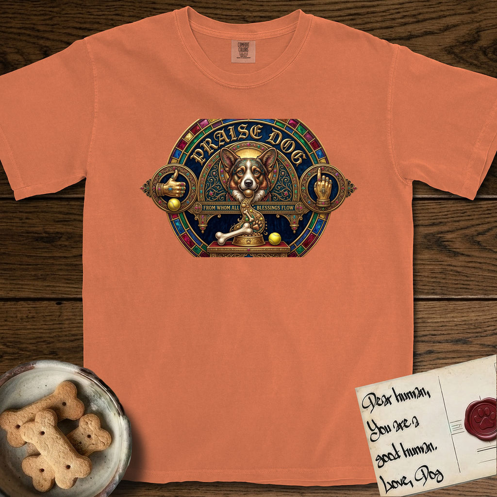 Praise Dog From Whom All Blessings Flow Corgi T-Shirt flat lay in Melon, featuring a jeweled baroque throne emblem with a Corgi at center, a golden gemstone frame, raised golden hands in blessing, and the words Praise Dog.
