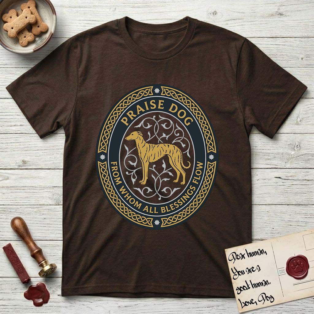 Praise Dog From Whom All Blessings Flow Galgo T-Shirt flat lay in Dark Chocolate, featuring a gold and navy oval medallion with a brindle Galgo standing in profile over silver filigree vines, a knotwork border, and the words Praise Dog From Whom All Blessings Flow.