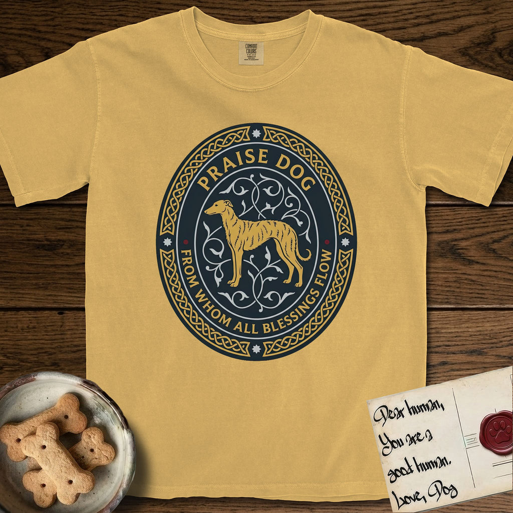Praise Dog From Whom All Blessings Flow Galgo T-Shirt flat lay in Mustard, featuring a gold and navy oval medallion with a brindle Galgo standing in profile over silver filigree vines, a knotwork border, and the words Praise Dog From Whom All Blessings Flow.