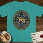 Praise Dog From Whom All Blessings Flow Galgo T-Shirt flat lay in Seafoam, featuring a gold and navy oval medallion with a brindle Galgo standing in profile over silver filigree vines, a knotwork border, and the words Praise Dog From Whom All Blessings Flow.