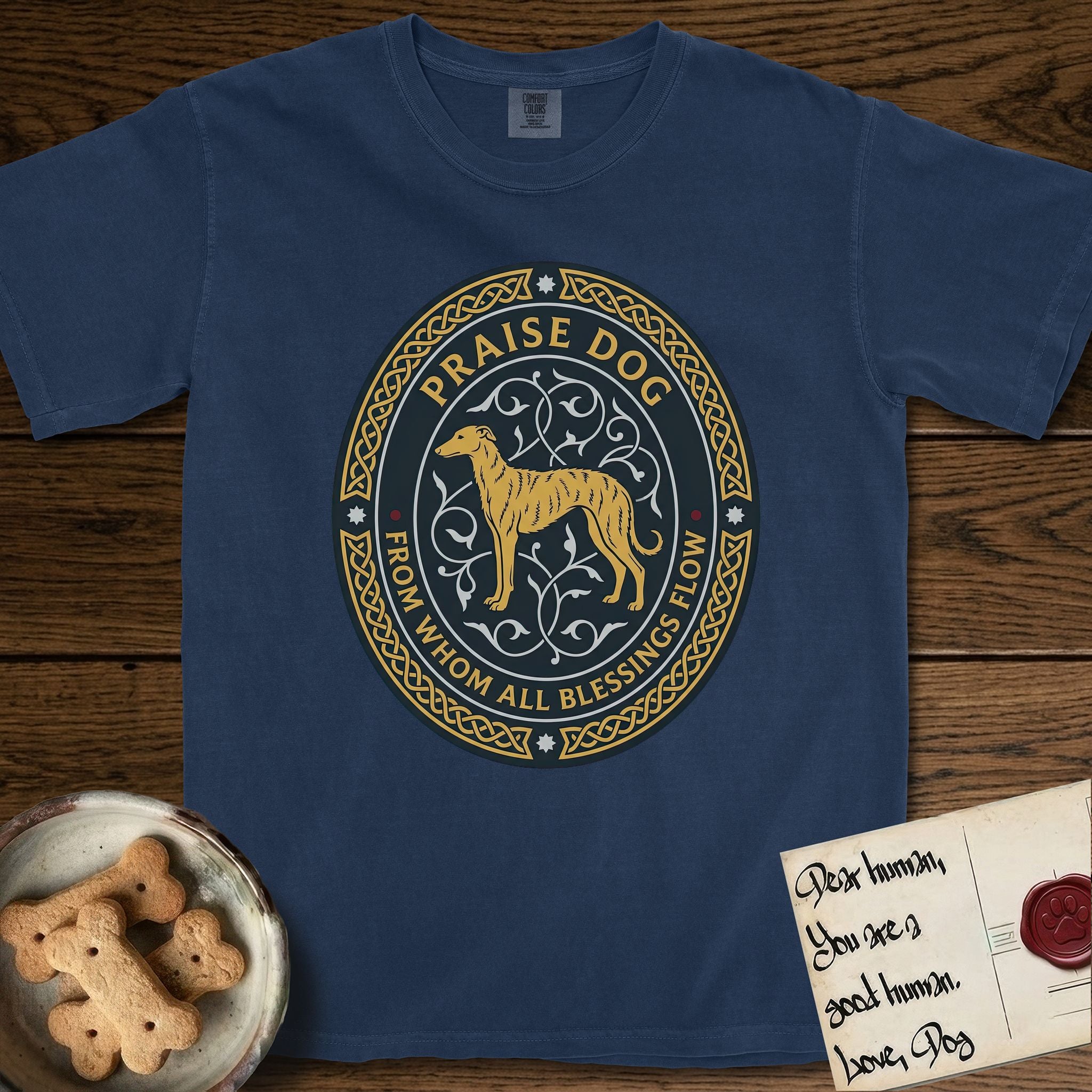 Praise Dog From Whom All Blessings Flow Galgo T-Shirt flat lay in True Navy, featuring a gold and navy oval medallion with a brindle Galgo standing in profile over silver filigree vines, a knotwork border, and the words Praise Dog From Whom All Blessings Flow.