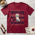 Praise Dog From Whom All Blessings Flow Golden Retriever T-Shirt flat lay in Antique Cherry Red, featuring a bold Western hand-lettered "Praise Dog" design in navy and gold with a haloed Golden Retriever at center.