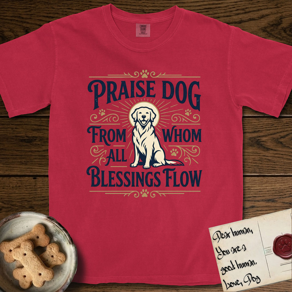 Praise Dog From Whom All Blessings Flow Golden Retriever T-Shirt flat lay in Red, featuring a bold Western hand-lettered "Praise Dog" design in navy and gold with a haloed Golden Retriever at center.