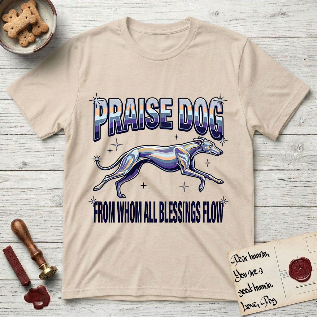 Praise Dog From Whom All Blessings Flow Greyhound T-Shirt flat lay in Sand, featuring a retro chrome airbrush design with a Greyhound running at full stretch among sparkle stars and the words Praise Dog From Whom All Blessings Flow in chrome sunset lettering.