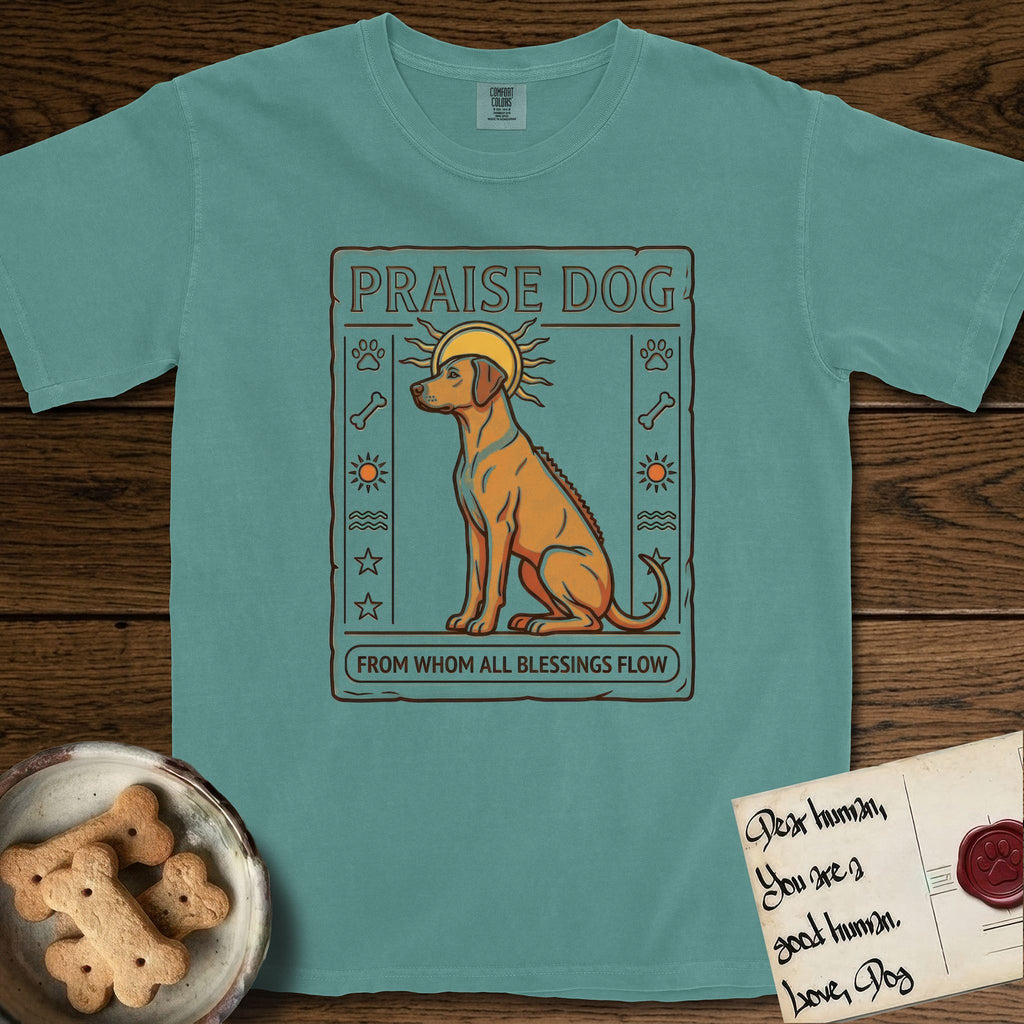 Praise Dog From Whom All Blessings Flow Rhodesian Ridgeback T-Shirt flat lay in Blue Spruce, featuring an ancient Egyptian carved-relief emblem of a Rhodesian Ridgeback in side profile with a visible spine ridge, a rayed golden sun halo, hieroglyph glyph columns, and a ragged stone border with "Praise Dog From Whom All Blessings Flow" lettering.